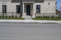 a building with the door open and on the sidewalk behind it is an empty street