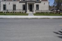 a building with the door open and on the sidewalk behind it is an empty street