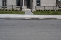 a building with the door open and on the sidewalk behind it is an empty street