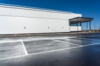 an empty parking lot with no people near it and lots of windows on one side