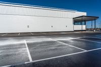 an empty parking lot with no people near it and lots of windows on one side