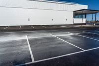 an empty parking lot with no people near it and lots of windows on one side