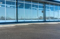 an empty commercial area with large glass windows in it's front entrance and a fire hydrant