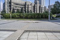 a person sitting at the bench in front of a mall that is empty of people