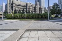 a person sitting at the bench in front of a mall that is empty of people