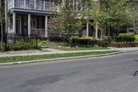 a person riding a skateboard down the middle of a street in a residential area