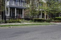 a person riding a skateboard down the middle of a street in a residential area