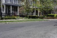 a person riding a skateboard down the middle of a street in a residential area