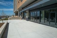 an outside courtyard with sliding glass doors to the entrance of a building on the campus