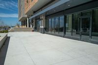 an outside courtyard with sliding glass doors to the entrance of a building on the campus