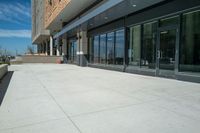 an outside courtyard with sliding glass doors to the entrance of a building on the campus