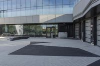 a view of an outside area of an office building with large windows and a circular driveway