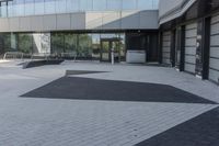 a view of an outside area of an office building with large windows and a circular driveway