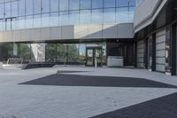 a view of an outside area of an office building with large windows and a circular driveway