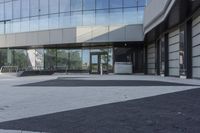 a view of an outside area of an office building with large windows and a circular driveway