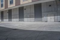 there is an empty sidewalk in front of buildings that are lined with garages and shutter