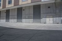 there is an empty sidewalk in front of buildings that are lined with garages and shutter