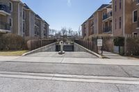 the street with several apartment buildings near it in a residential area of a city on a sunny day