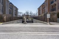 the street with several apartment buildings near it in a residential area of a city on a sunny day