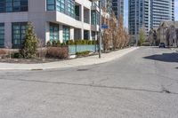 an image of a road with building and street sign in background at daytime time,