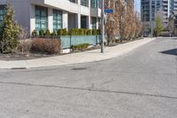 an image of a road with building and street sign in background at daytime time,