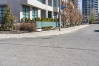 an image of a road with building and street sign in background at daytime time,