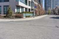 an image of a road with building and street sign in background at daytime time,