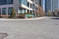 an image of a road with building and street sign in background at daytime time,