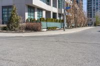 an image of a road with building and street sign in background at daytime time,