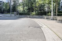 a car driving down an empty street lined with tall buildings and trees in the background