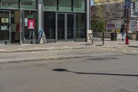 a man with a red fire hydrant and skateboard in the middle of an empty city street