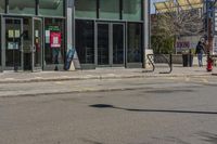 a man with a red fire hydrant and skateboard in the middle of an empty city street