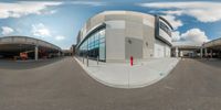 a street view showing buildings and an intersection through a fisheye lens lense at the same time