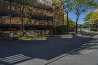 a big brick building that is on a street corner near some trees and other buildings