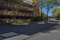 a big brick building that is on a street corner near some trees and other buildings