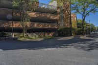 a big brick building that is on a street corner near some trees and other buildings