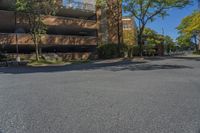 a big brick building that is on a street corner near some trees and other buildings