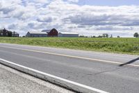 Road in Ontario countryside with trees and blue sky