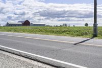 Road in Ontario countryside with trees and blue sky