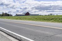 Road in Ontario countryside with trees and blue sky