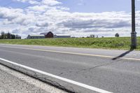 Road in Ontario countryside with trees and blue sky