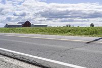 Road in Ontario countryside with trees and blue sky