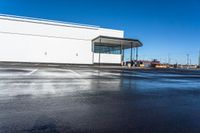 the empty car dealership at the intersection of highway and highway signs with a blue sky in the background