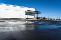 the empty car dealership at the intersection of highway and highway signs with a blue sky in the background