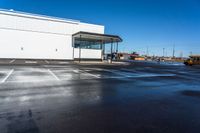 the empty car dealership at the intersection of highway and highway signs with a blue sky in the background