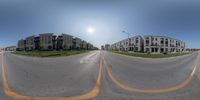 there are many buildings next to each other and an empty street in the middle of town