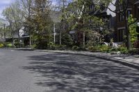 empty street with some residential neighborhood in the background in early springtime on clear day