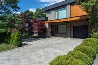 this house features a large driveway and stone path leading to the front door of the house