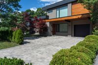 this house features a large driveway and stone path leading to the front door of the house