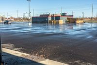 a view down an empty parking lot in the daytime, with only one person walking outside